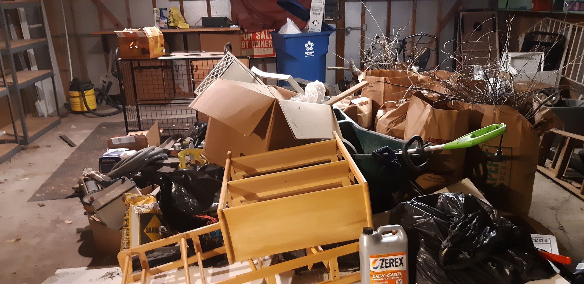 A garage filled with lots of trash and boxes.