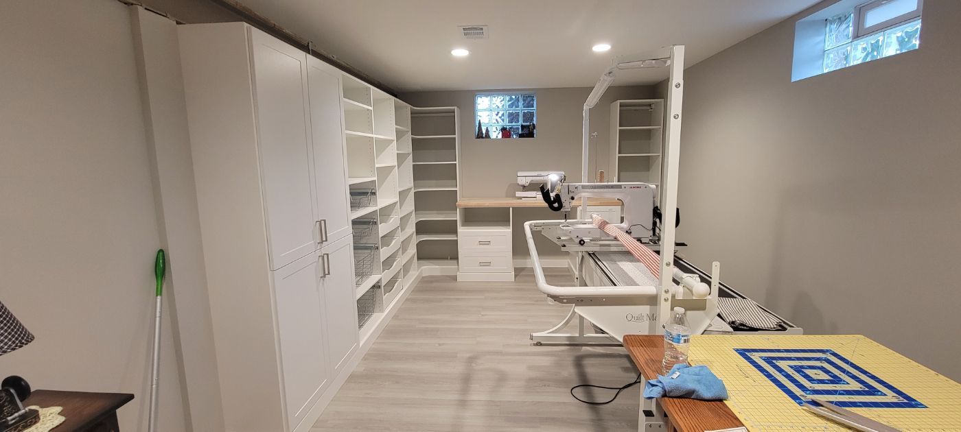 a room with a lot of shelves and a sewing machine in it .