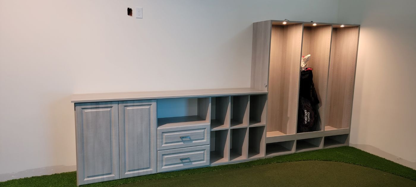 a room with a lot of cabinets and a green carpet .