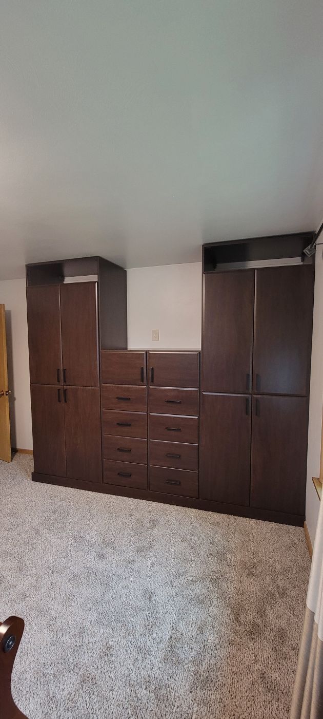 there are a lot of cabinets and drawers in this room .