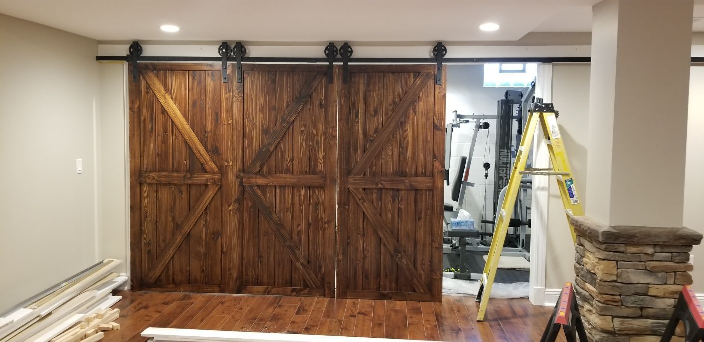 a room with a ladder and a sliding barn door .