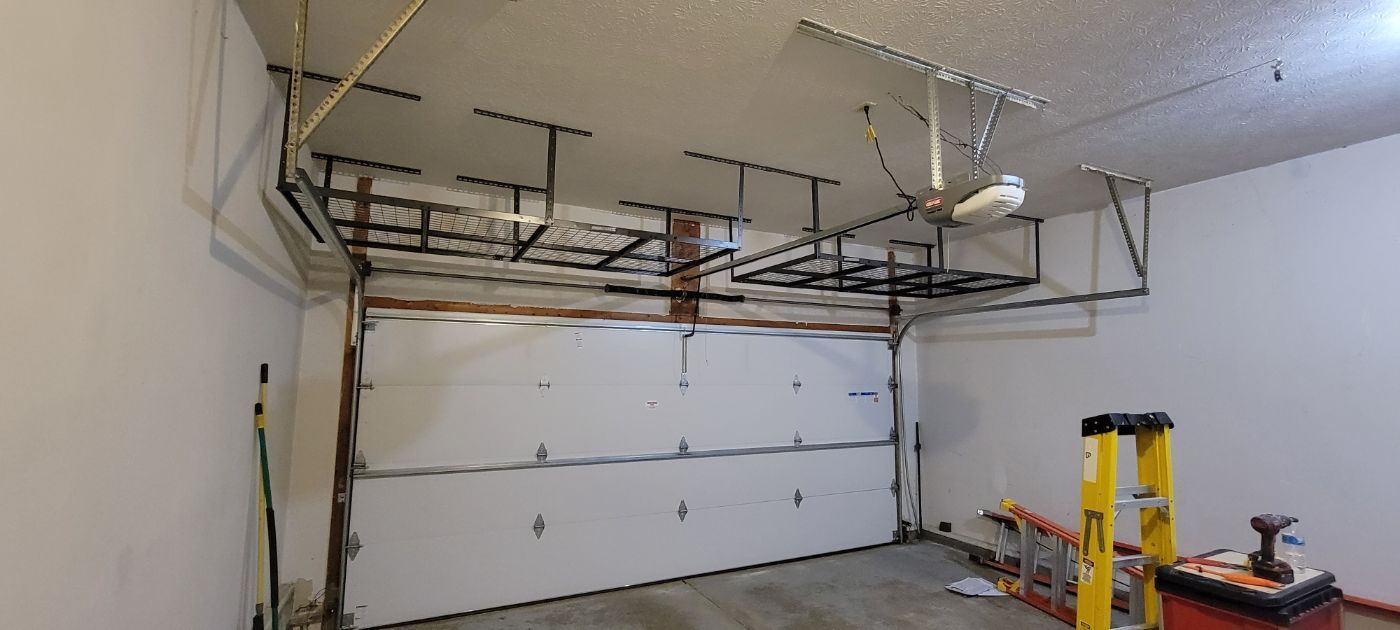 a garage with a garage door open and a ladder .
