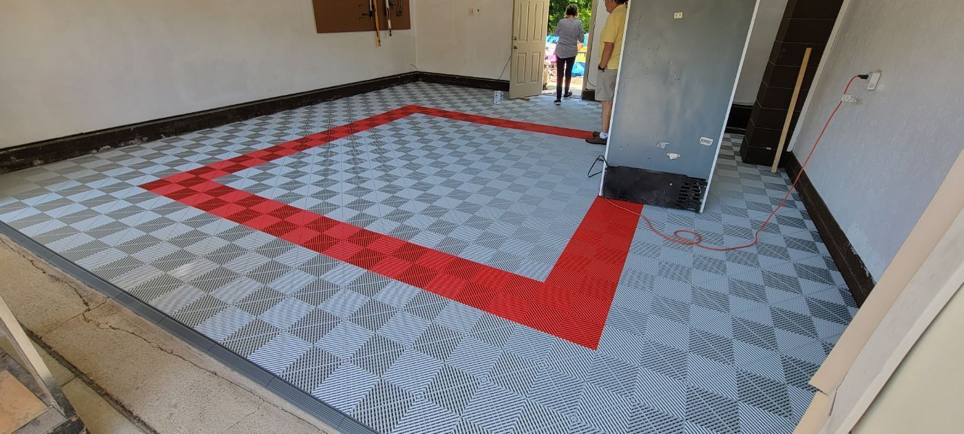 a room with a patterned floor and a red and white border .