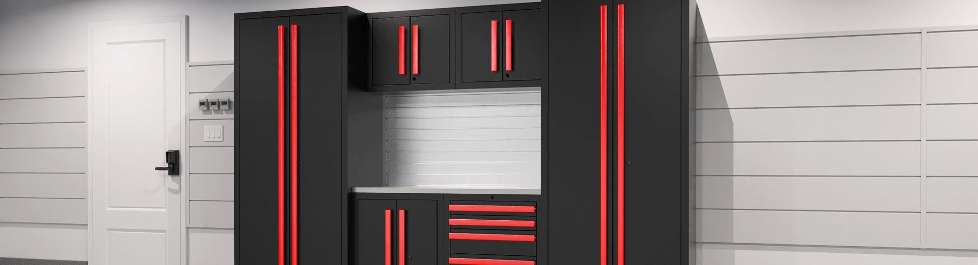 Black and red garage cabinets against a white wall and door.