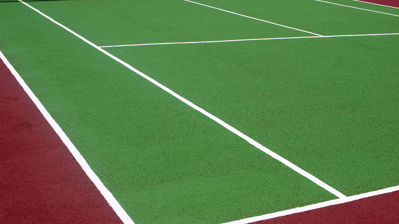 Close-up of a green textured tennis court surface with sharp white lines during a court installation service in San Tan Valley, AZ
