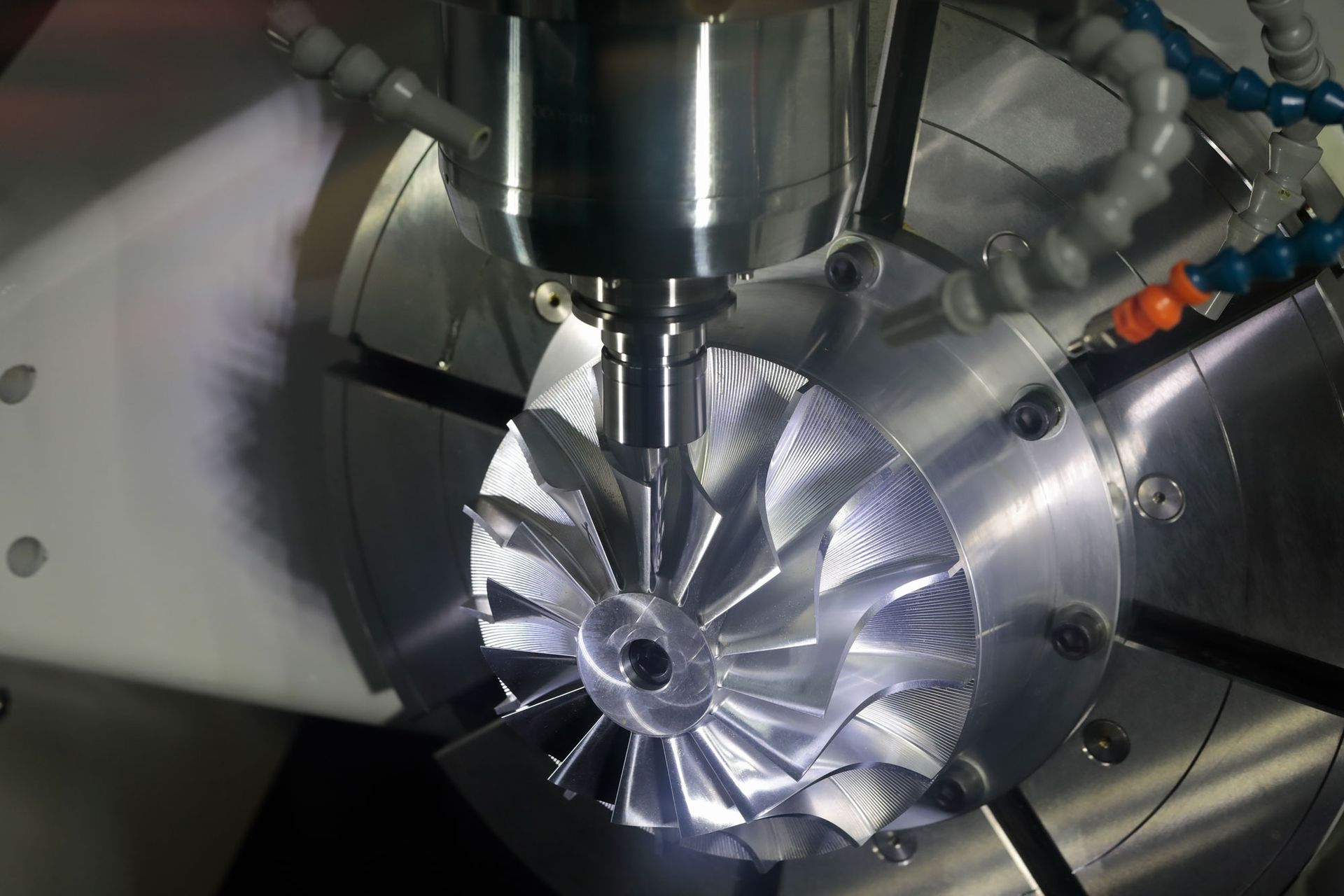 A machine is cutting a piece of metal that looks like a fan A machine is cutting a piece of metal that looks like a fan