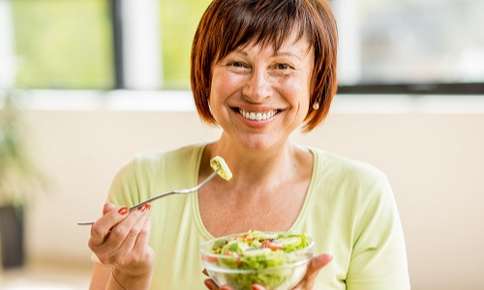 Adult Woman Eating Veggies — Sunnyside, WA — Yakima Valley Chiropractic Center