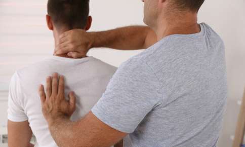 Man Treating Backpain with Chiropractic — Sunnyside, WA — Yakima Valley Chiropractic Center