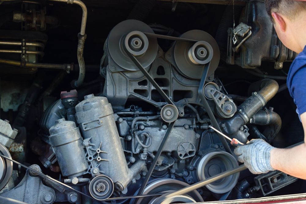 Mechanic Working on Bus Engine, Checking Belts and Pulleys — A1 Mobile Safety Certificates in Edmonton, QLD