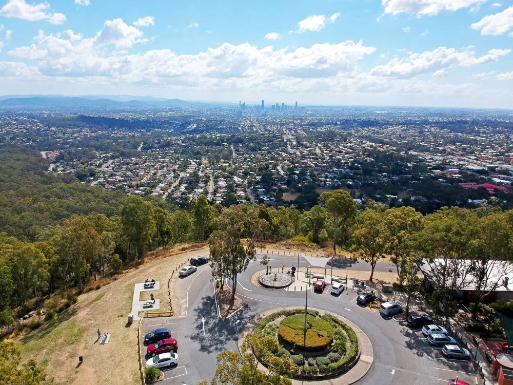 An Aerial View of A Parking Lot on Top of A Hill Overlooking a City — Ryde Energy in Brisbane, QLD