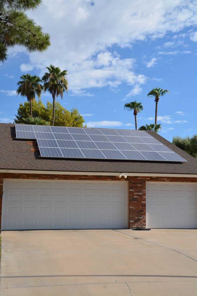 A House with Two Garage Doors and Solar Panels on The Roof — Ryde Energy in Ipswich, QLD