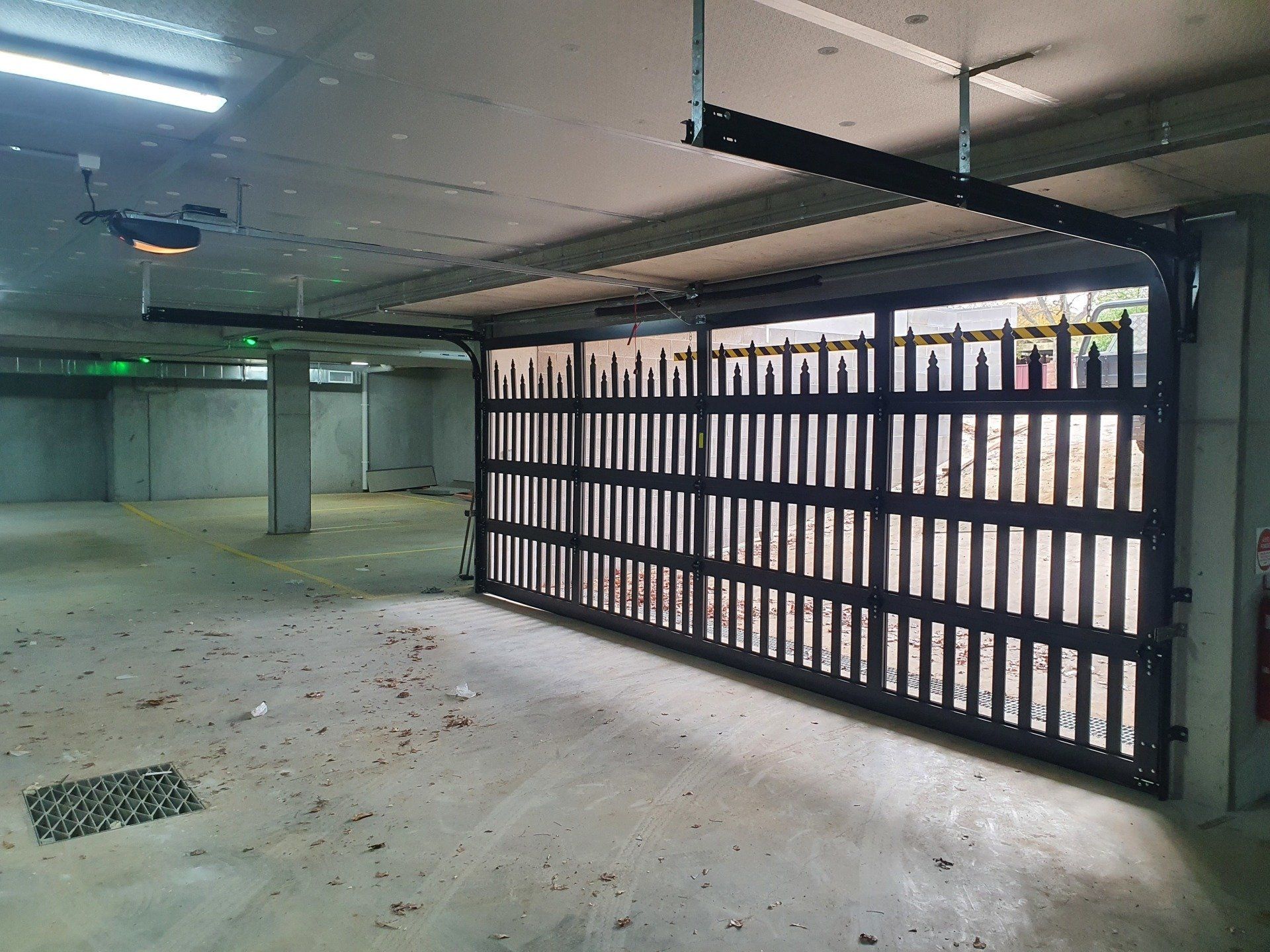A garage with a sliding gate that is open