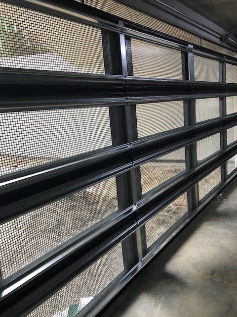 A garage door with a screen on it and a lot of windows.