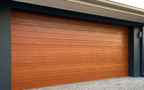 A close up of a wooden garage door on a house.