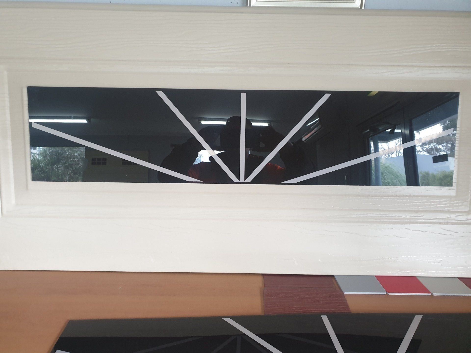 A window with a geometric design on it is sitting on a table.