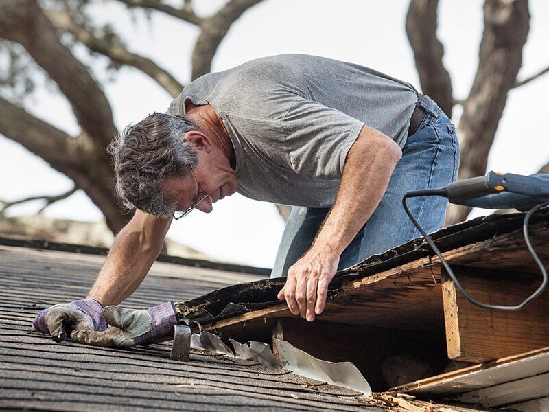 Man Fixing a Roof — Roofing in Moranbah, QLD