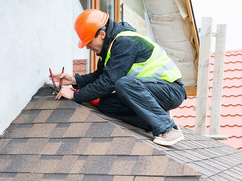 Worker Repairing Roof — Roofing in Moranbah, QLD