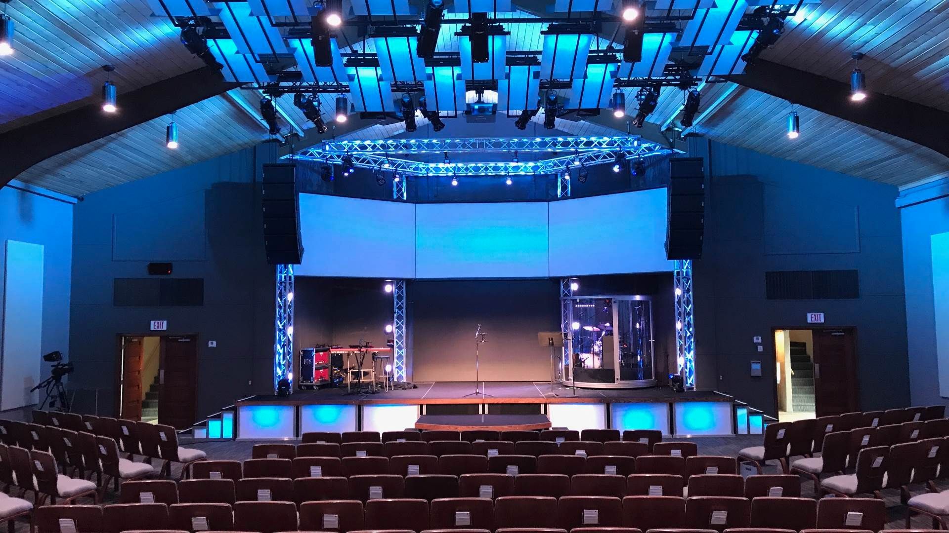 A large auditorium with rows of seats and a stage