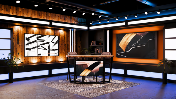 A television studio with a table , chairs , and a large screen.