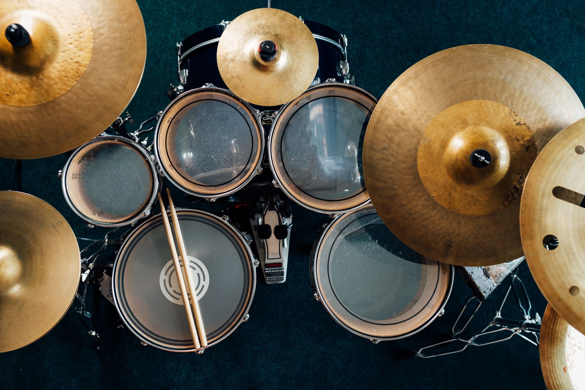 An aerial view of a drum set with cymbals and drumsticks