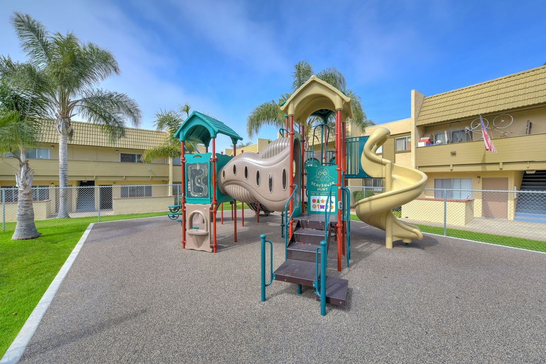 a children 's playground with a slide and stairs