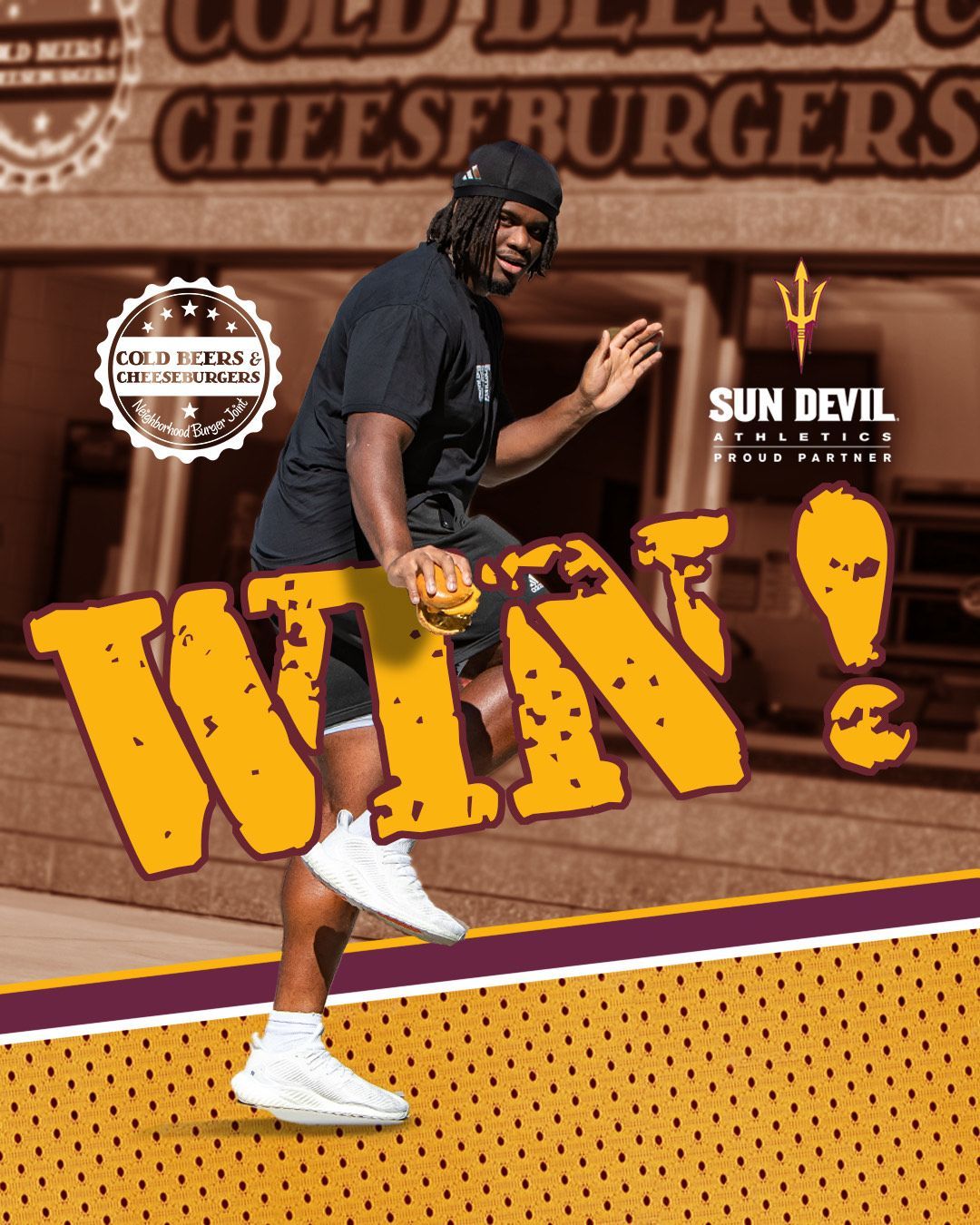 A man holding a hamburger in front of a sign that says win