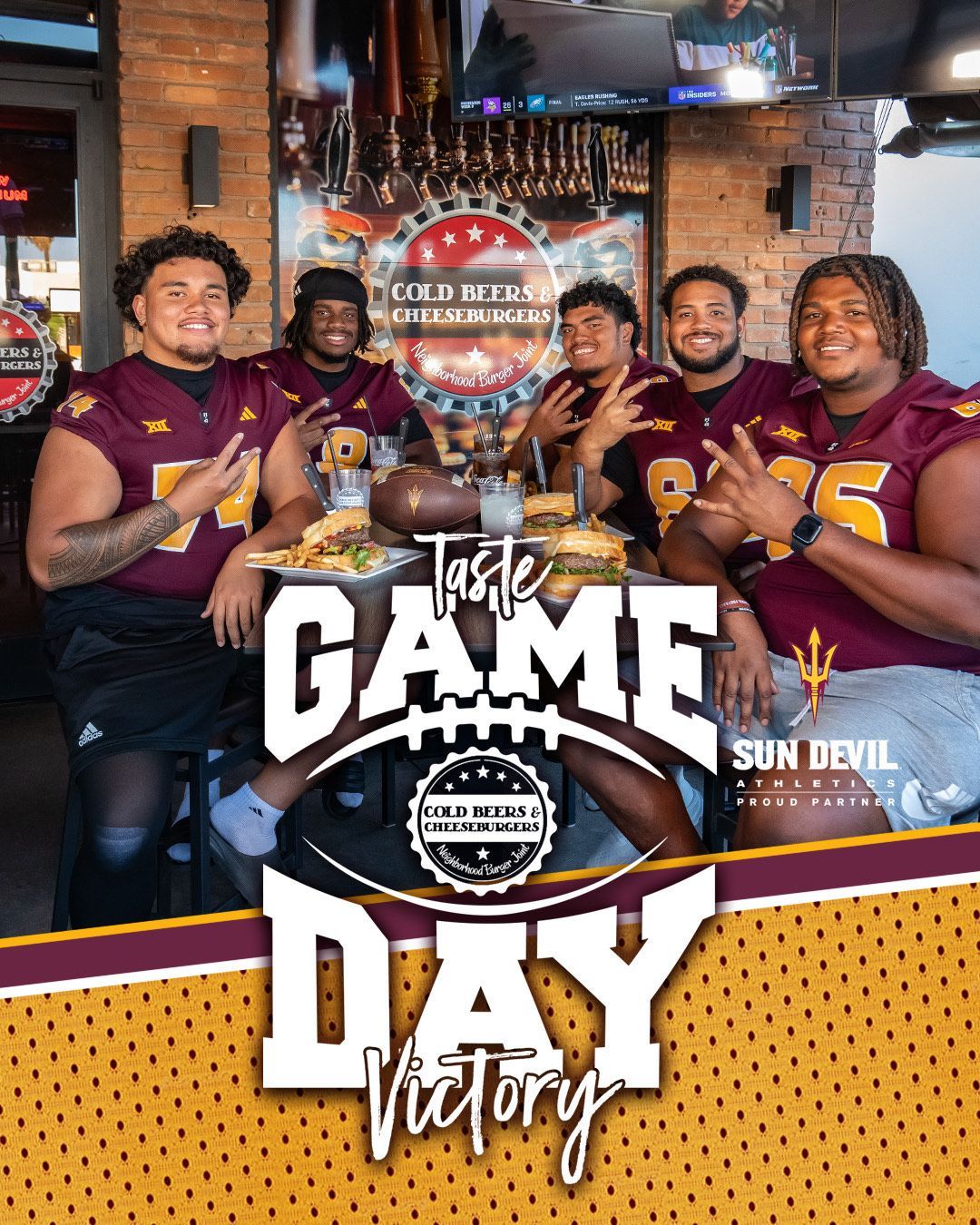 A group of football players are sitting at a table in a restaurant.