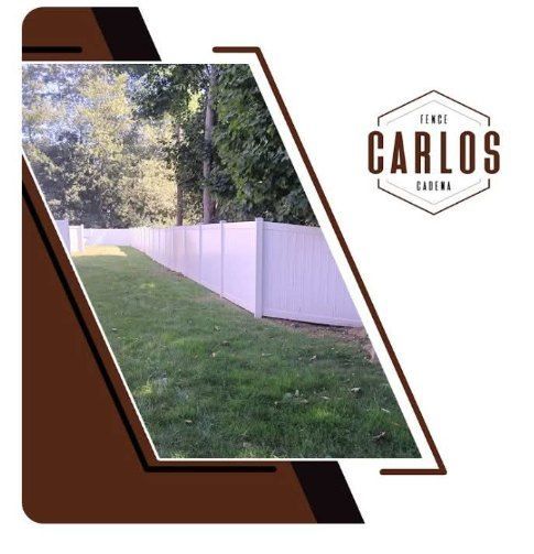 White fence along a grassy yard, logo