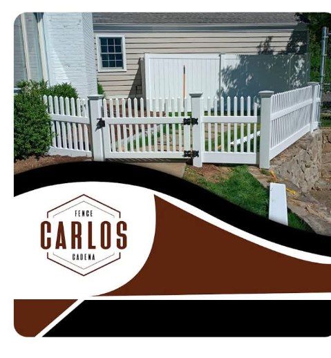 White picket fence with gate, Carlos Cadena logo in lower left.