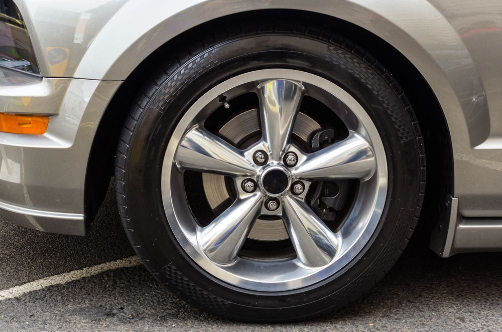 A close up of a car wheel with a tire on it
