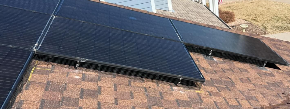 A close up of a roof with solar panels on it.