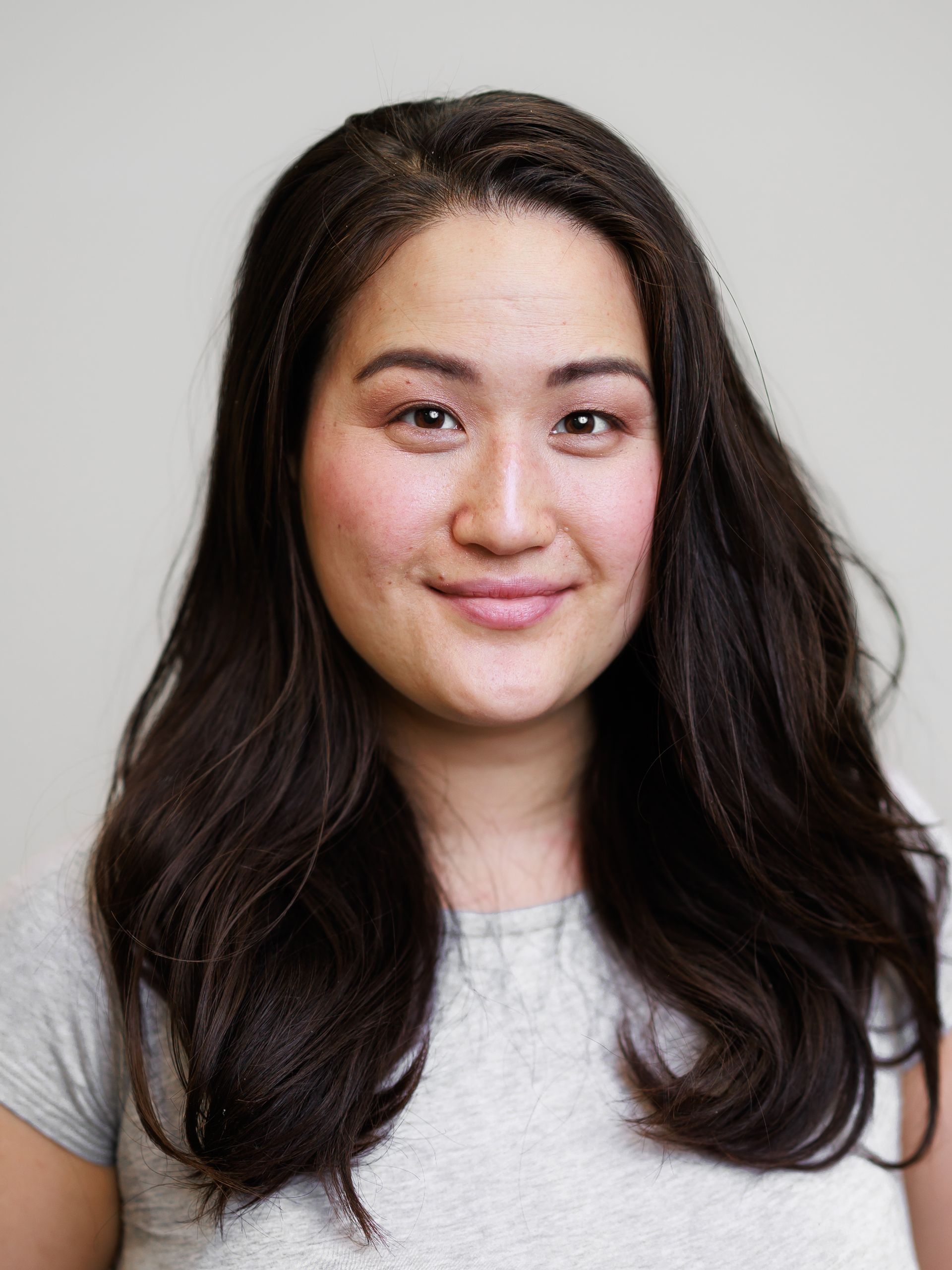 A woman in a black sweater is posing for a picture. Toronto Headshot Photography