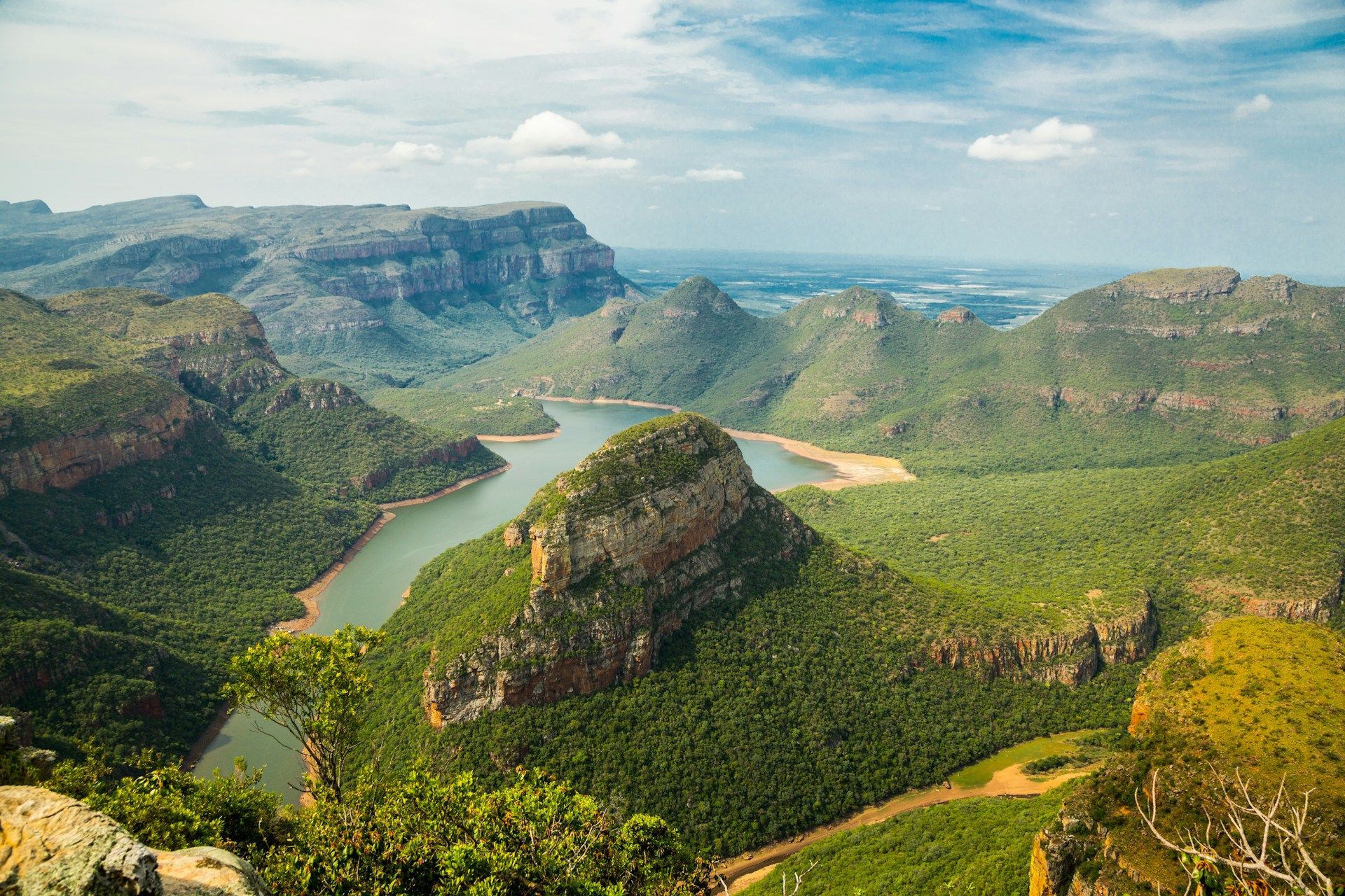 A river runs through a valley surrounded by mountains.