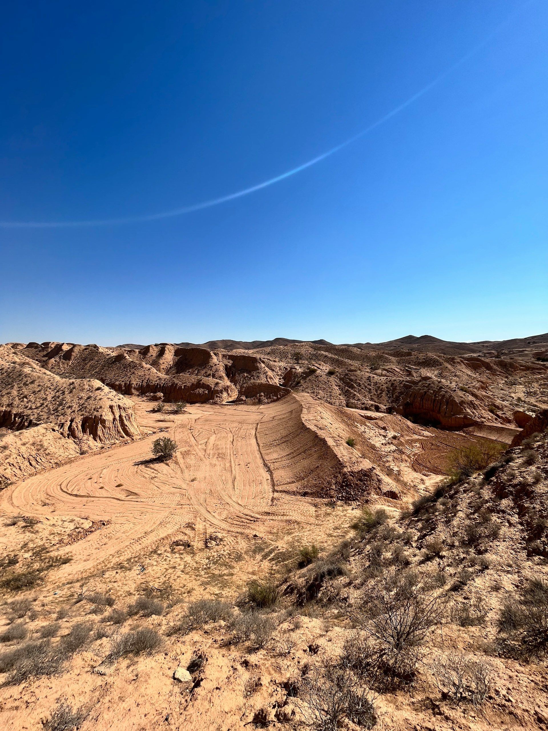 A desert landscape with a blue sky in the background