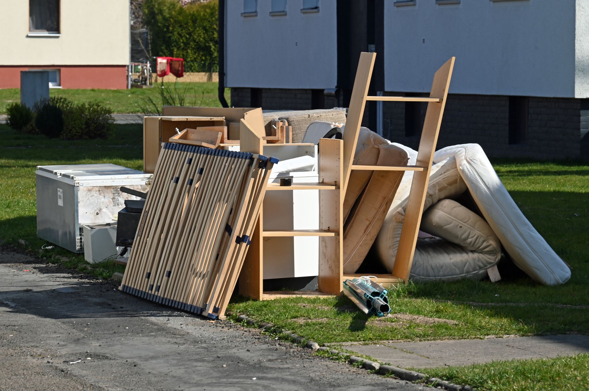 A pile of furniture is sitting on the side of the road