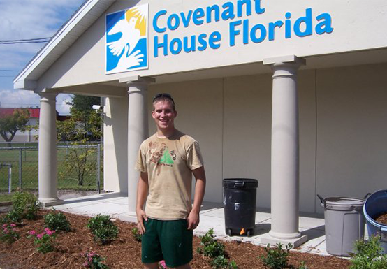 Image of young male standing outside Covenant House Florida building