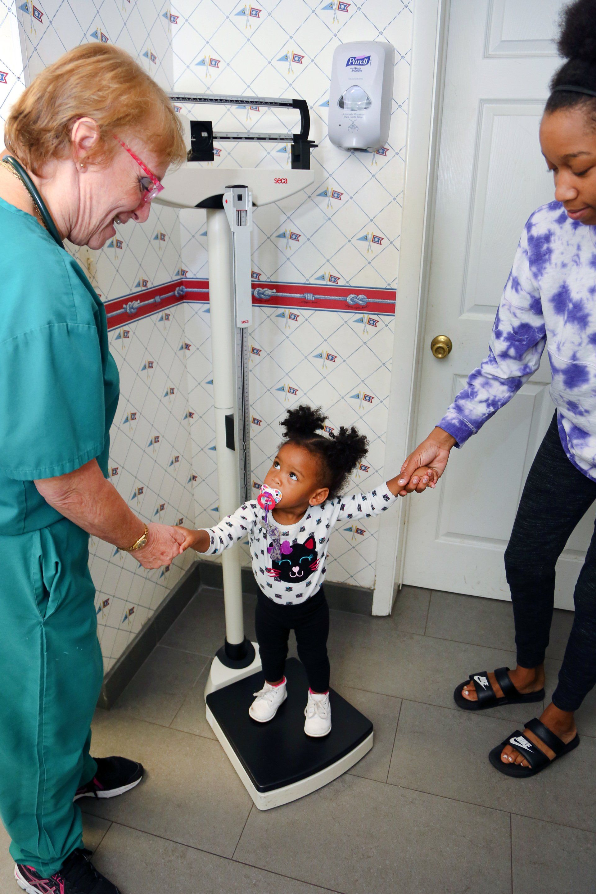 image of child and mother with a nurse at doctor office