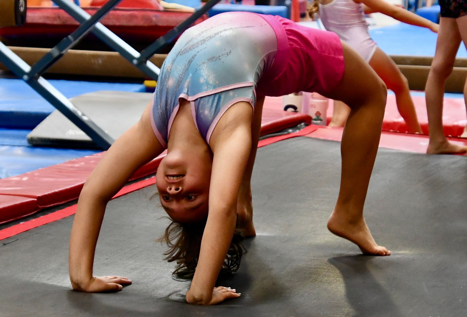 A picture of a little girl doing a backbend on the Tumble Trak
