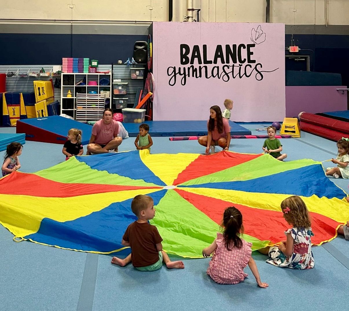 children and parents enjoying the parachute during a parent-tot class