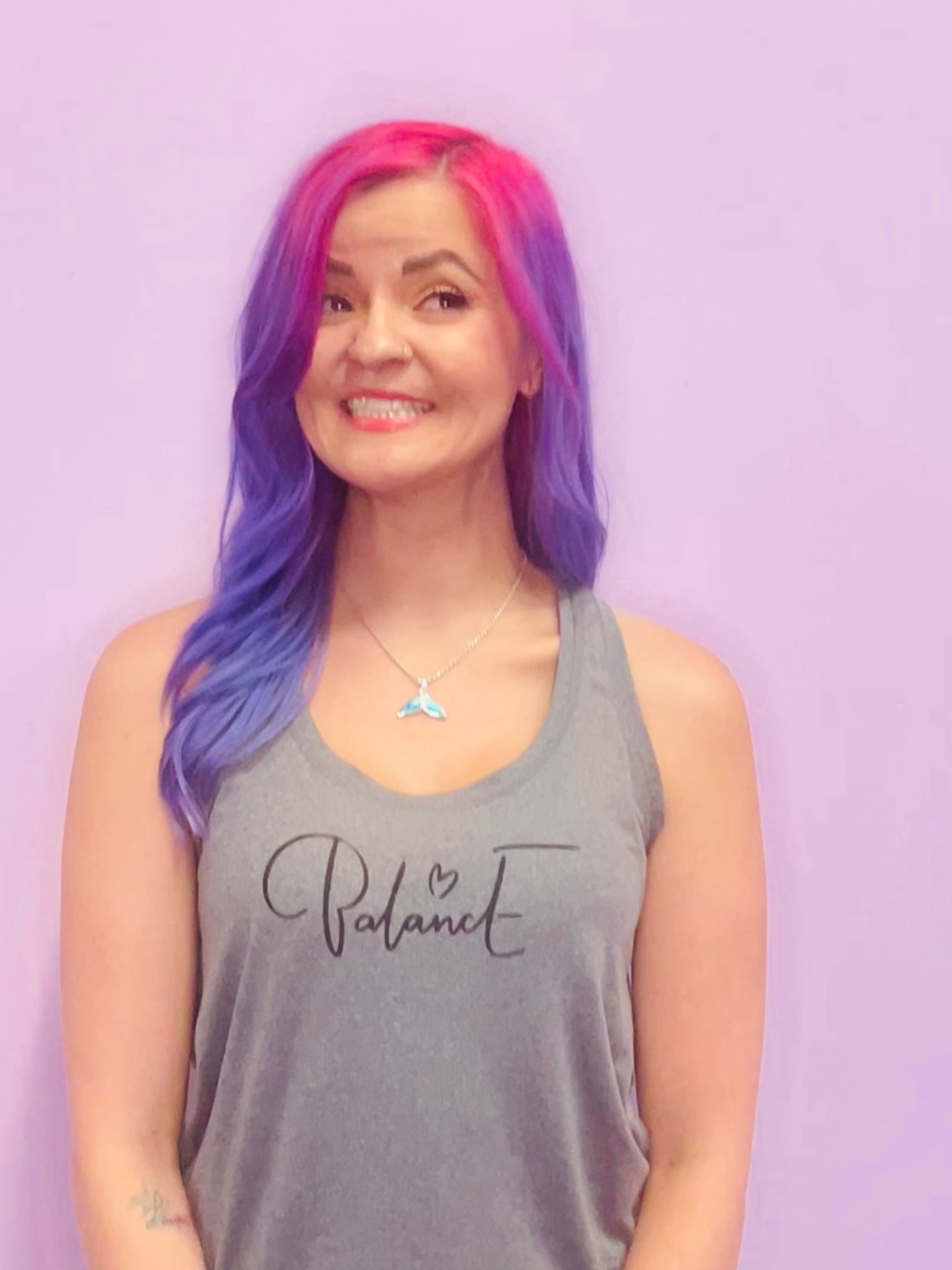 A picture of one of our owers, Coach Mallory, with her pink and purple hair