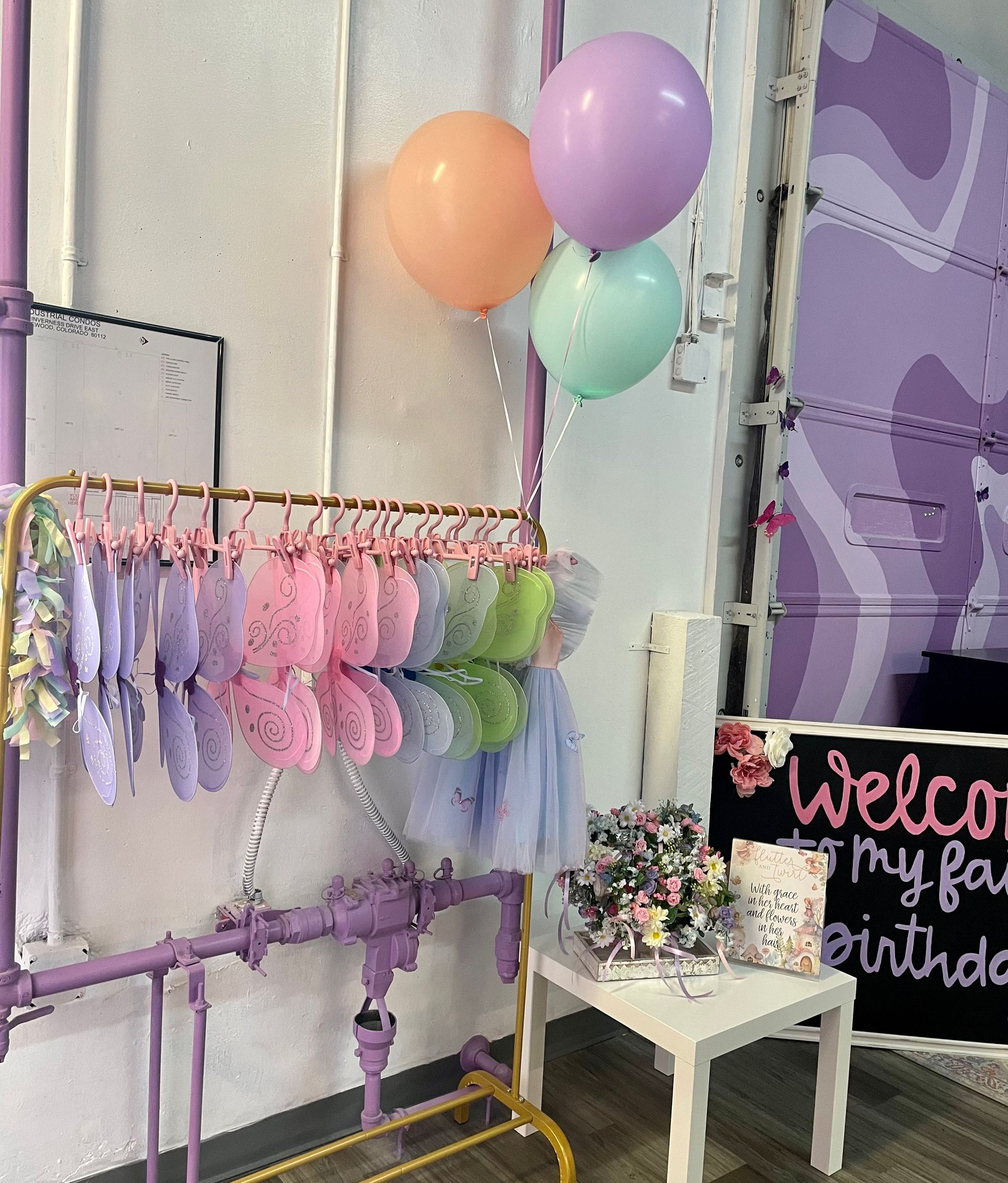 A picture of pink, purple, and mint balloons and decorations for a child's party