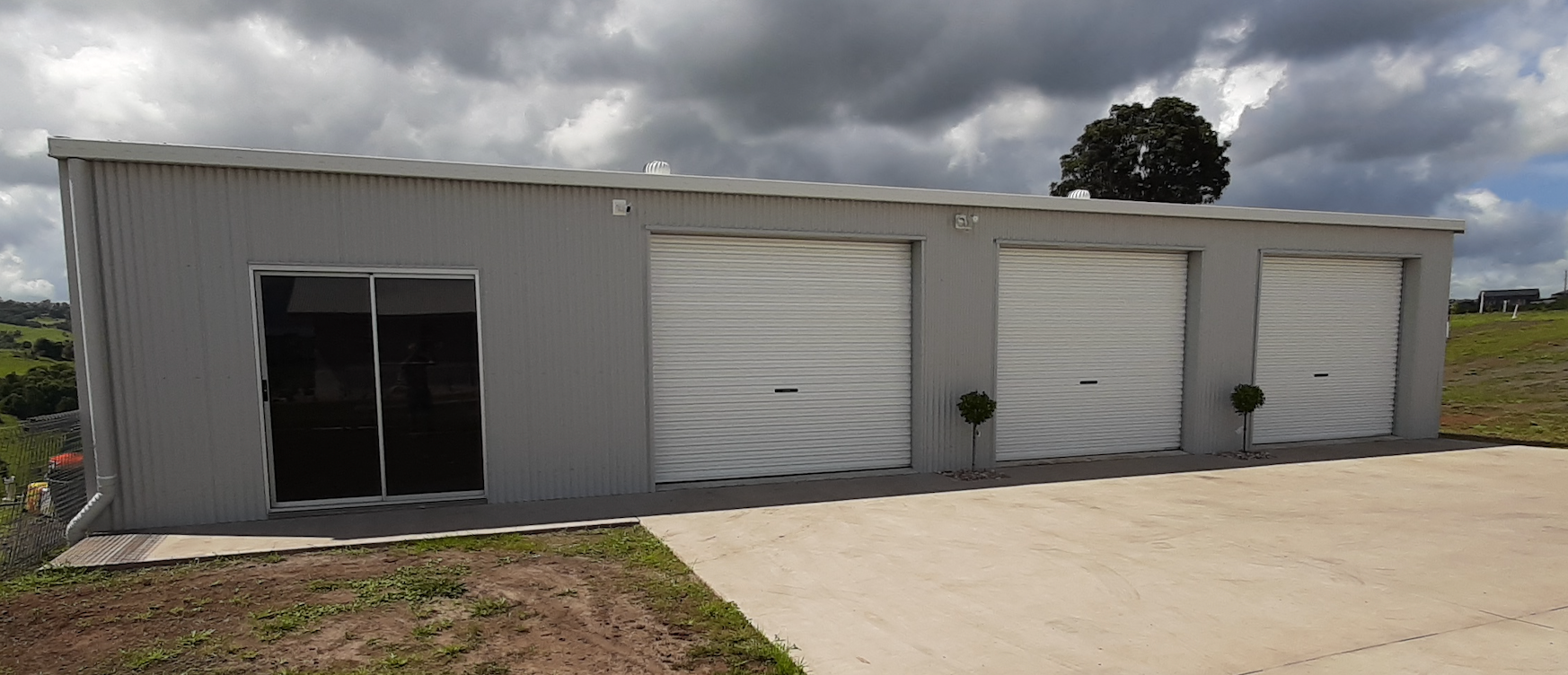 Double Garage Shed with White Roller Doors — Shed Kits in Yamba, NSW