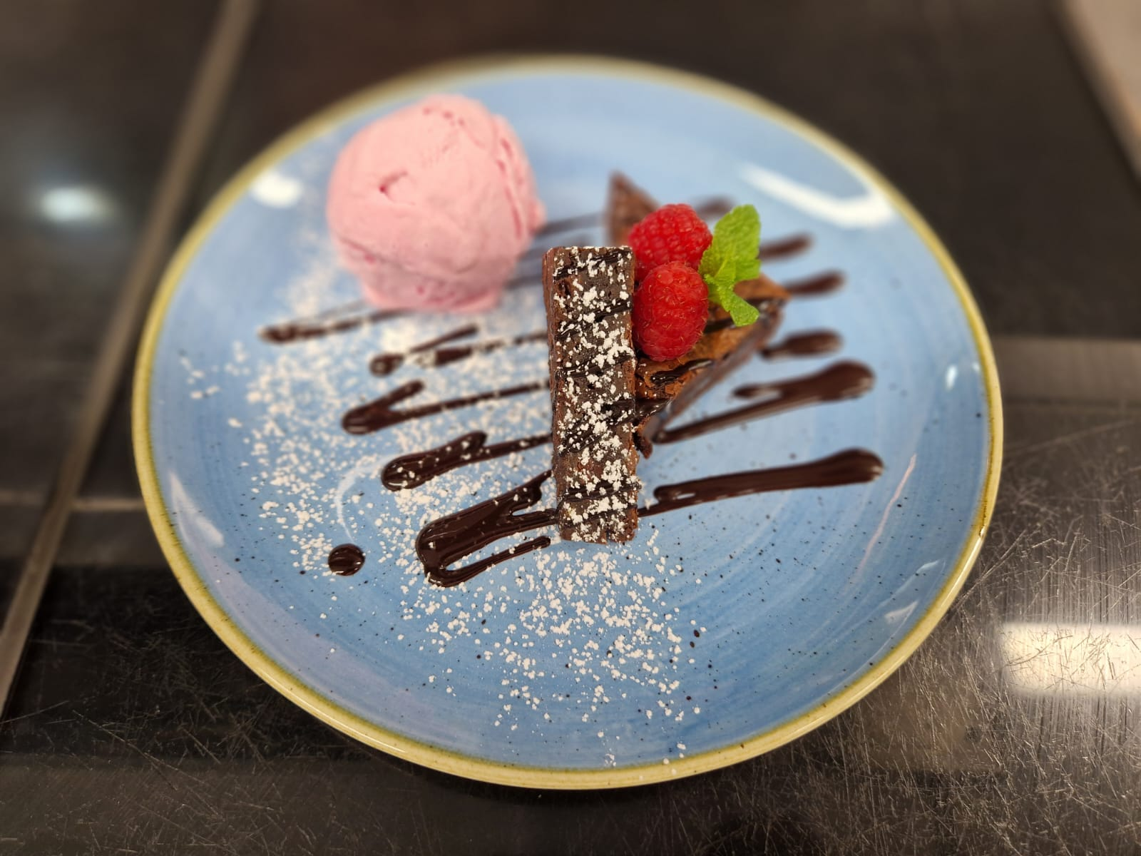 Chocolate dessert with raspberries and ice cream, highlighting quality catering beyond common myths