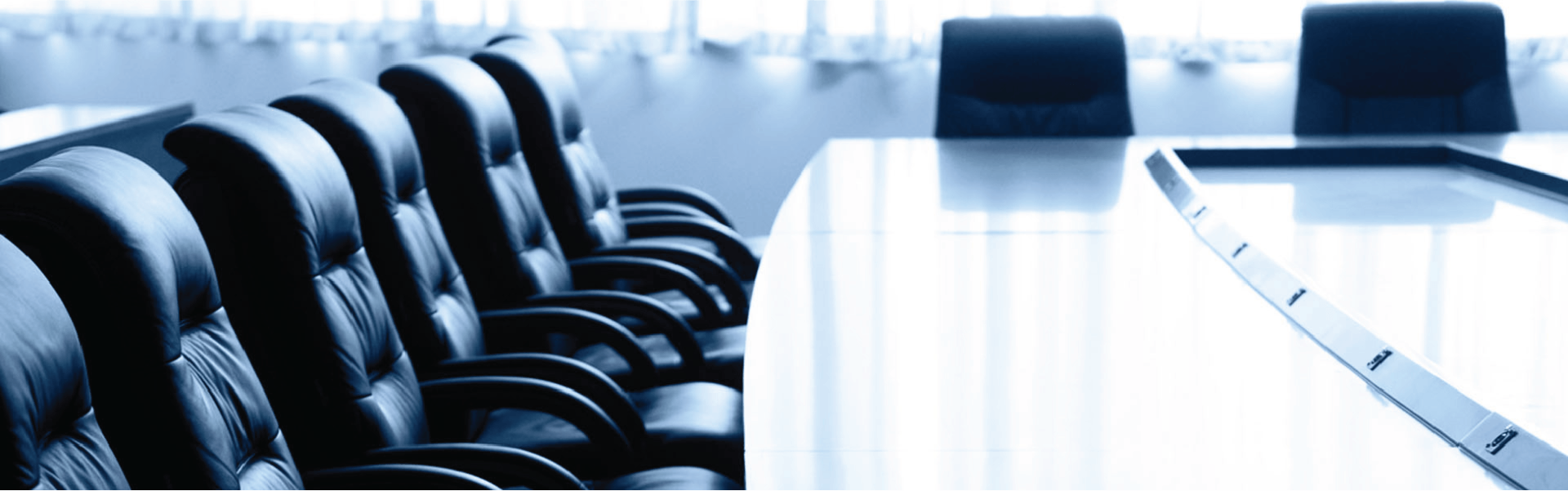 A conference room with a long table and chairs