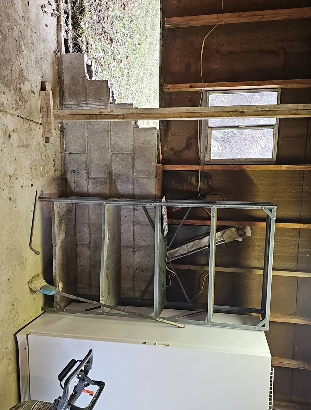 Construction site with cinder block walls, exposed studs, framing, and drywall.