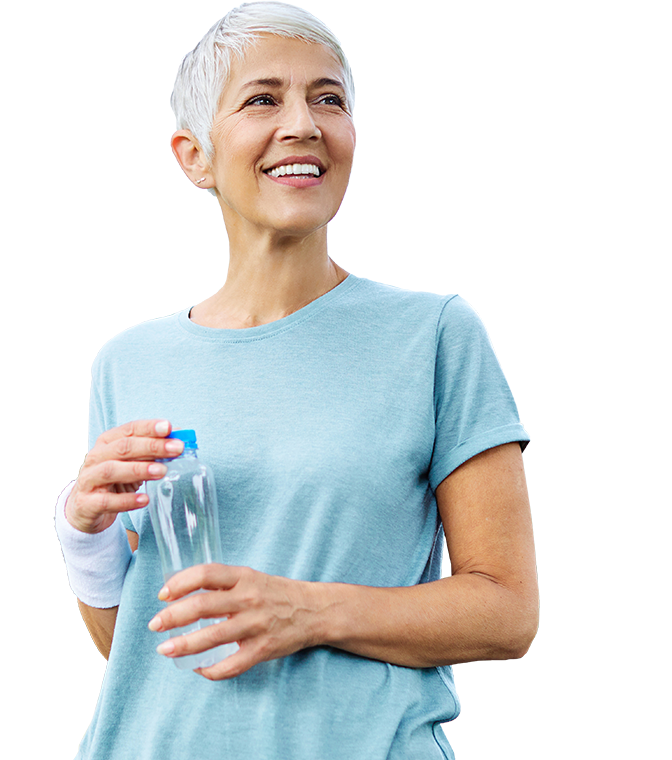 A woman in a blue shirt is holding a bottle of water.