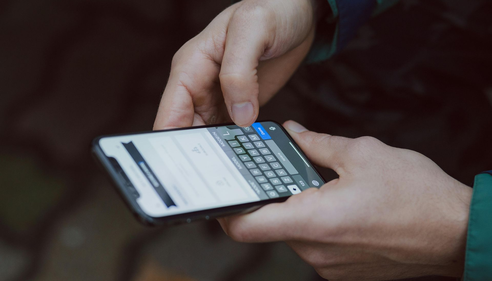 Person typing on their mobile phone