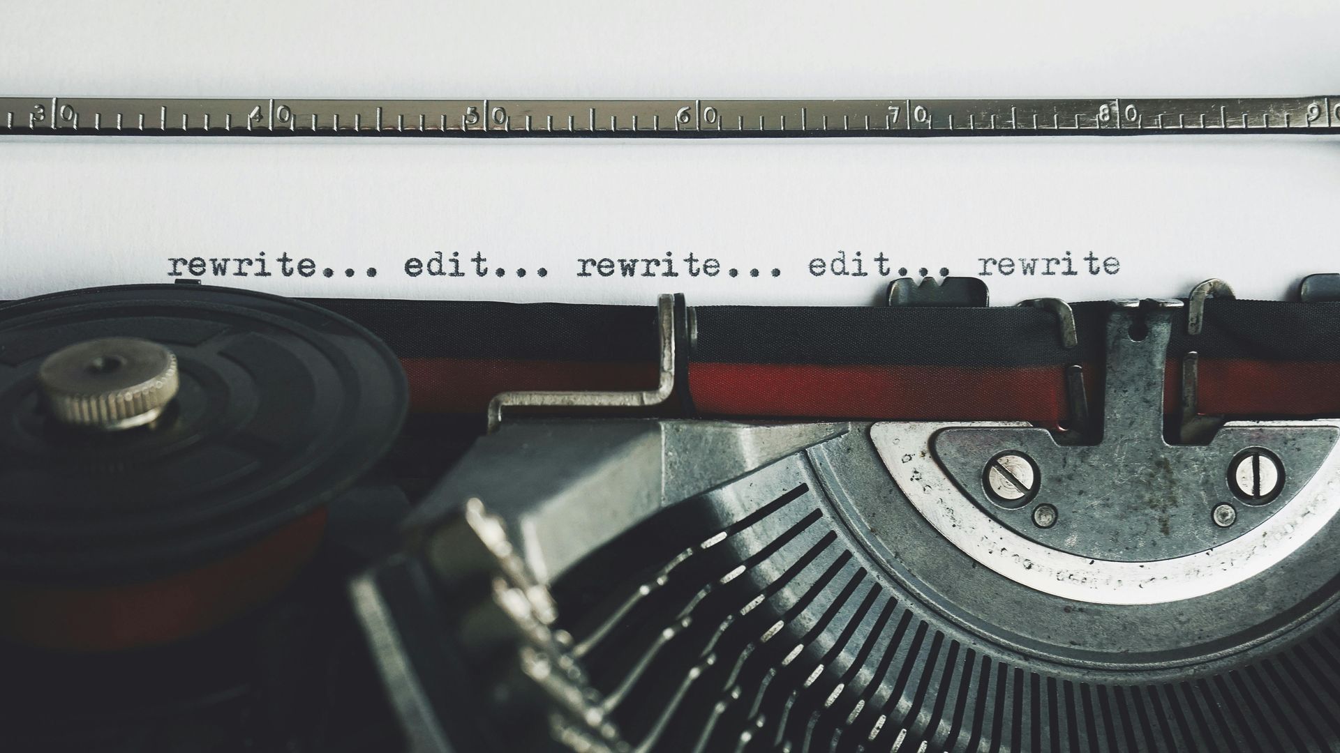 Typewriter with the words 'rewrite...edit' repeatedly typed