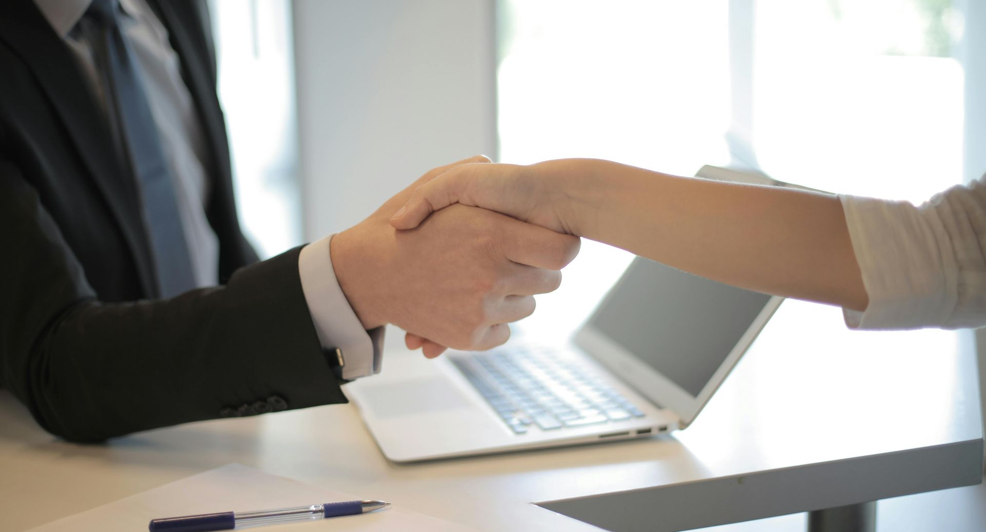 Two people in an office shaking hands
