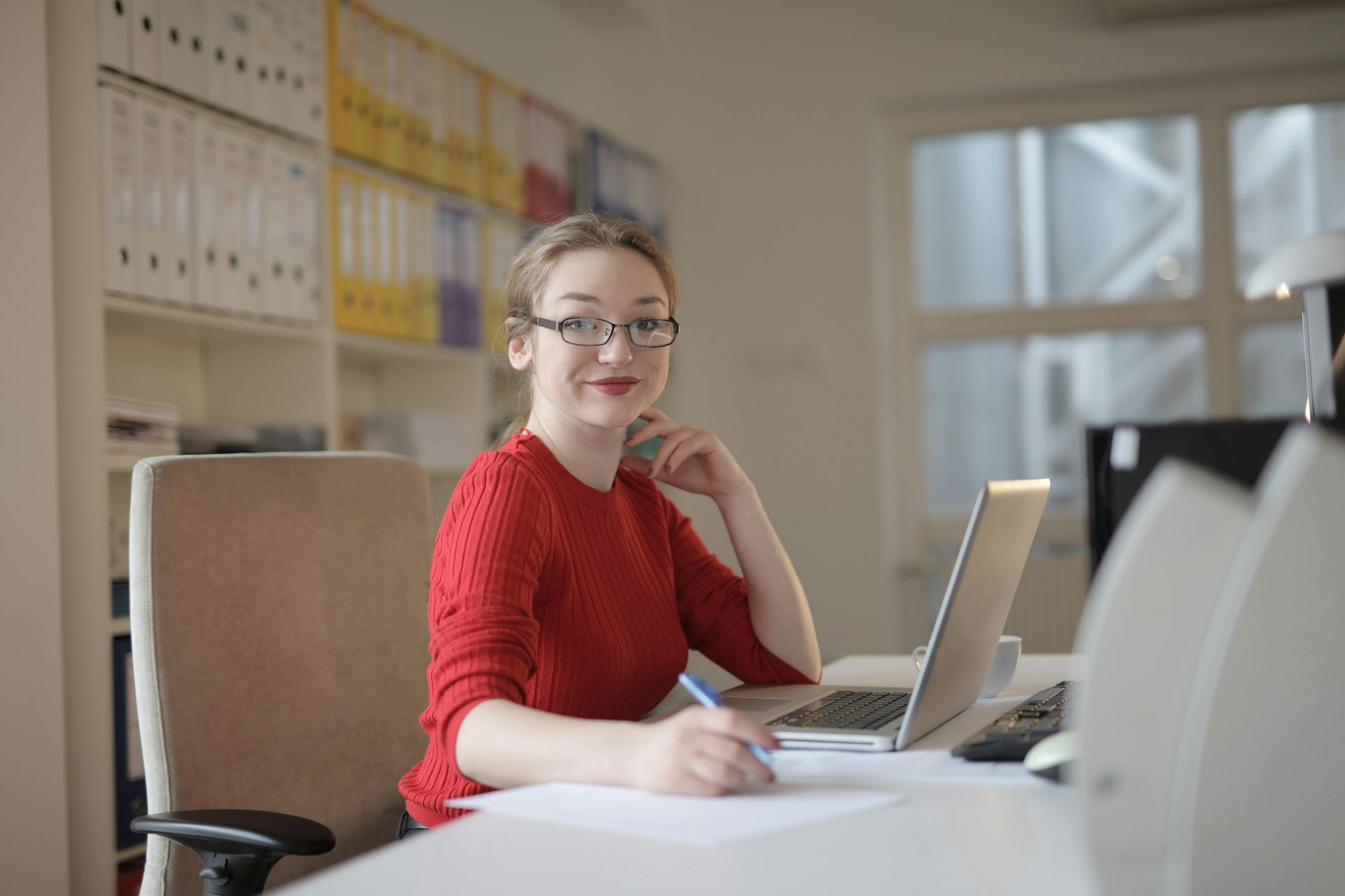 Smiling assistant sitting at their desk